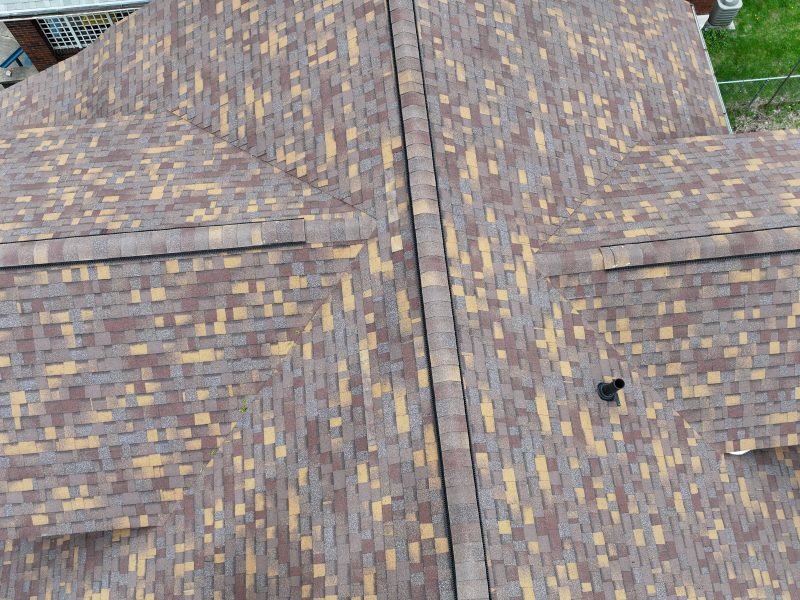 Close drone view of a new blended brown and tan architectural shingle roof